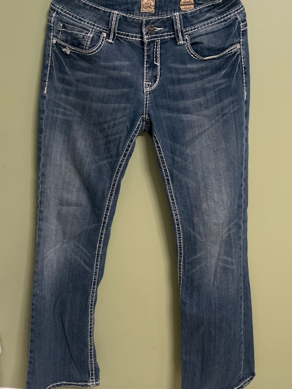 Studio 5 low rise bootcut jeans with white embroidered floral designs on back